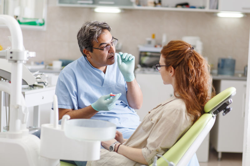 Dentist communicating with a patient about dental care.